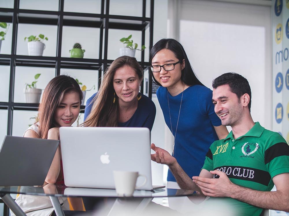 group of people looking at computer
