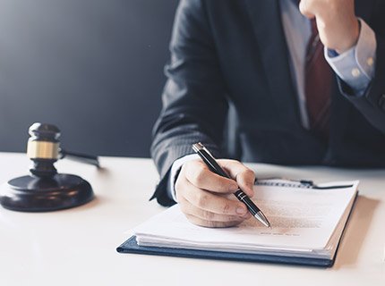 man signing forms